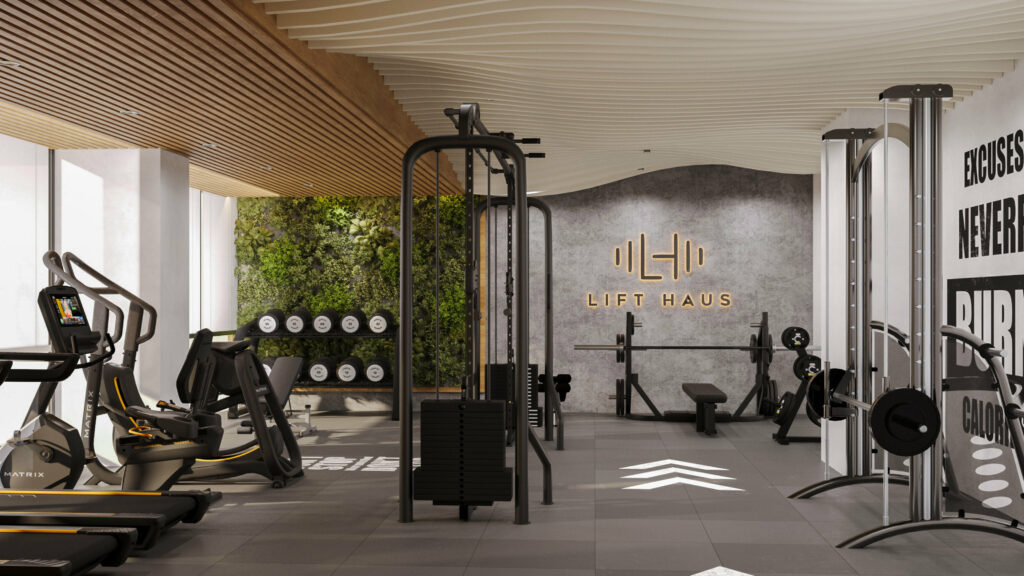 Modern hotel gym with training equipment, green wall, and open layout for wellness-focused design.