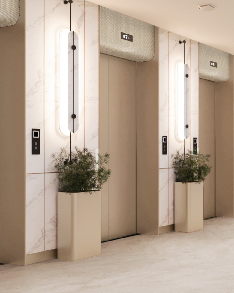 Hotel elevator lobby with marble finishes, soft lighting, and integrated greenery elements.