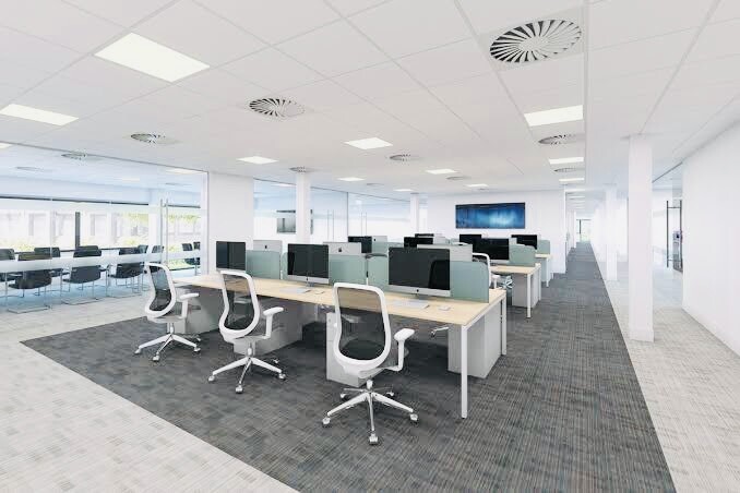 Open-plan office with clean desk arrangement, clear circulation paths, and optimized workspace layout.