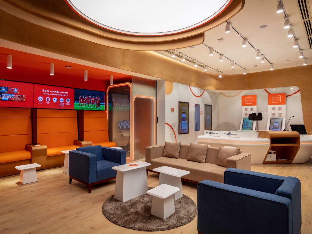 Digital banking branch with hospitality-inspired seating, warm lighting, and customer-focused spatial design.