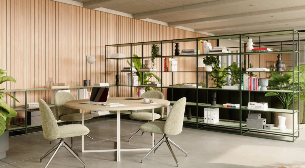 Modern office with biophilic design elements including natural light, greenery, and wood finishes supporting employee wellbeing.