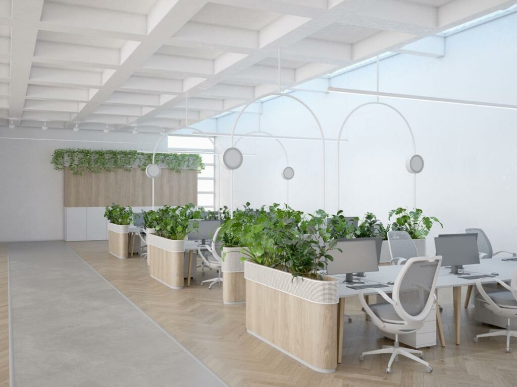 Modern office with biophilic design elements including natural light, greenery, and wood finishes supporting employee wellbeing.